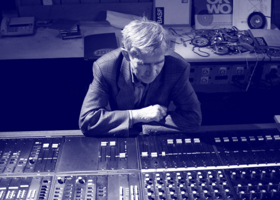 Zdjęcie Eugeniusza Rudnika, siedzącego za konsolą w studiu. | Photo of Eugeniusz Rudnik sitting behind the console in the studio.